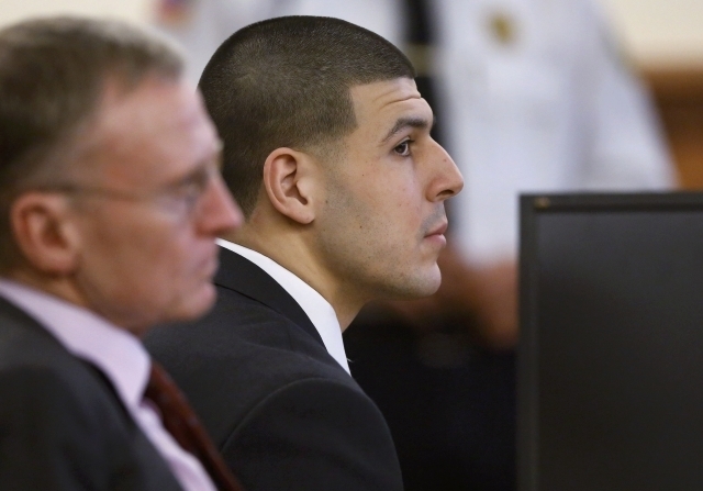 Former New England Patriots football player Aaron Hernandez, right, listens during his trial as defense attorney Charles Rankin looks on in Fall River, Massachusetts, Thursday, Jan. 29, 201 ...
