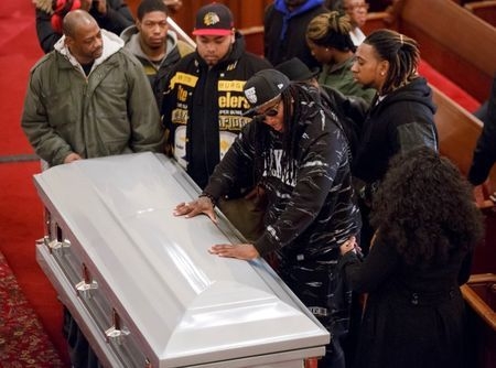 Friends of Akai Gurley stand by his coffin during his wake at Brown Memorial Baptist Church in Brooklyn, New York,Dec. 5, 2014. (Reuters/The New York Times/Richard Perry/Pool)
