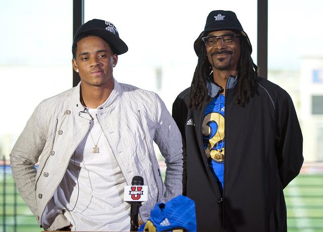 Recording artist Snoop Dogg stands beside his son Cordell Broadus during a press conference ...