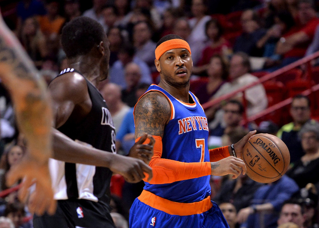 Feb 9, 2015; Miami, FL, USA; New York Knicks forward Carmelo Anthony (7) dribbles the ball against Miami Heat forward Luol Deng (9) during the first half at American Airlines Arena. (Steve Mitchel ...