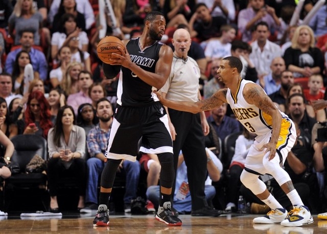 Jan 23, 2015; Miami, FL, USA; Miami Heat guard Dwyane Wade (3) is pressured by Indiana Pacers guard George Hill (3) during the second half at American Airlines Arena. Heat won 89-87. (Steve Mitche ...
