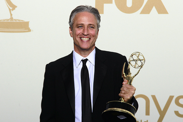 Television host Jon Stewart holds the Emmy award for the "The Daily Show With Jon Stewart" at the 63rd Primetime Emmy Awards in Los Angeles, in this file photo taken September 18, 2011. Comedian J ...