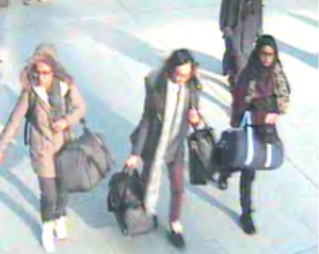 British teenage girls Amira Abase, left, Kadiza Sultana and Shamima Begun walk through Gatwick airport before they boarded a flight to Turkey on Feb. 17, 2015, in this still handout image taken fr ...