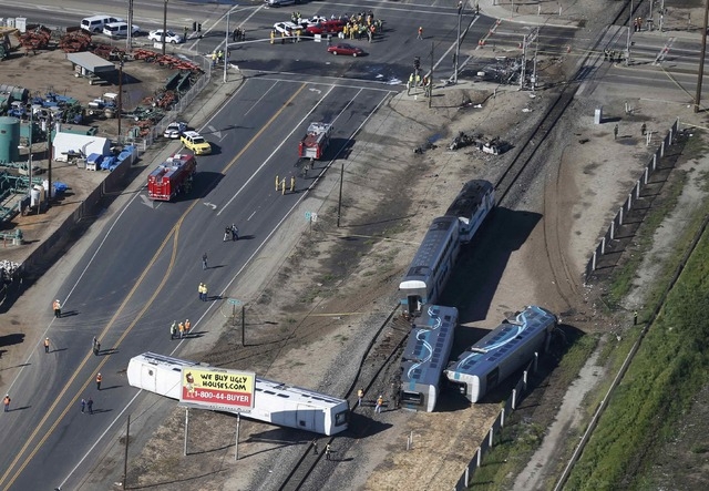 An aerial view shows the scene of a double-decker Metrolink train derailment in Oxnard, California February 24, 2015.  A Los Angeles-bound commuter train slammed into a tractor trailer stopped on  ...