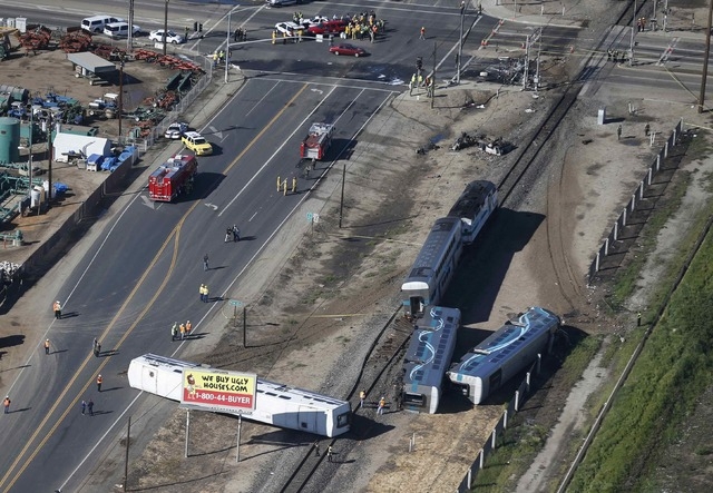 An aerial view shows the scene of a double-decker Metrolink train derailment in Oxnard, California February 24, 2015. A Los Angeles-bound commuter train slammed into a tractor trailer stopped on ...