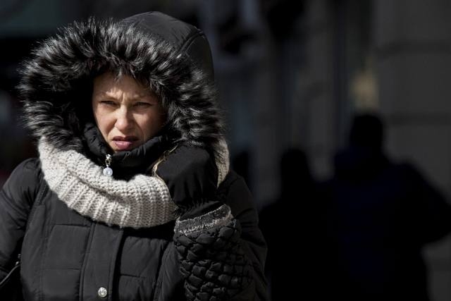People walk through the cold in the Manhattan borough of New York, February 24, 2015. New York faced another day of extreme cold that brought record-breaking temperatures, a low of 6 degrees was s ...
