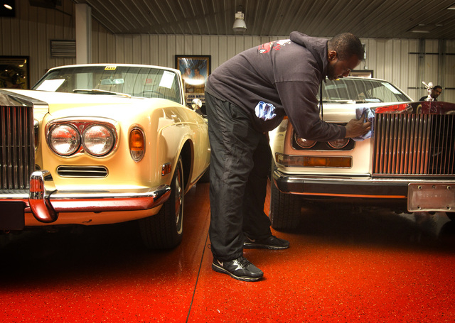 Steven Bruce details a 1972 Rolls Royce Camague at the Rogers' Classic Car Museum, 1480 Gragson Avenue, on Tuesday, Feb. 3, 2015. On the left is a 1972 Rolls-Royce Corniche Convertible. (Jeff Sche ...