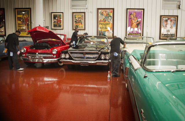 Workmen detail automobiles at the Rogers' Classic Car Museum, 1480 Gragson Avenue, on Tuesday, Feb. 3, 2015. Nearly 250 cars owned by the late businessman Jim Rogers will be auctioned off on Sat ...