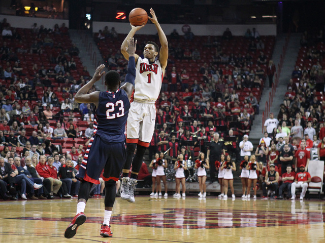 UNLV guard Rashad Vaughn takes a 3-point shot over Fresno State guard Marvelle Harris during the first half of their Mountain West Conference game Tuesday, Feb. 10, 2015, at the Thomas & Mack Cent ...