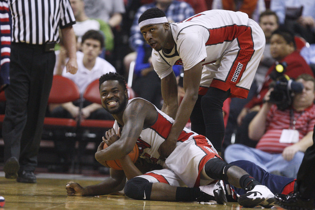 UNLV forward Goodluck Okonoboh helps up guard Jordan Cornish after Cornish forced a held ball situation with Fresno State guard Marvelle Harris during the first half of their Mountain West Confere ...