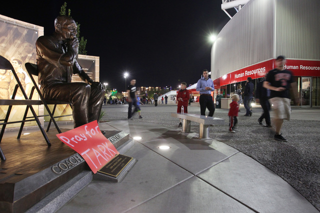A sign wishing former UNLV basketball coach Jerry Tarkanian well rests on a sculpture of him in front of the Thomas & Mack before the Rebels game against Fresno State Tuesday, Feb. 10, 2015. (Sam  ...