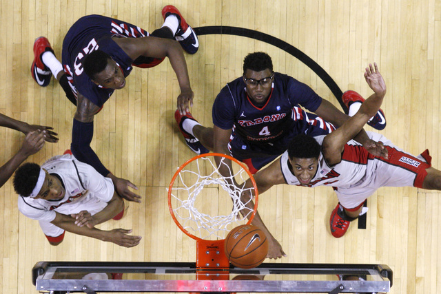 UNLV forward Christian Wood watches two of his 27 points roll in while being defended by Fresno State forward Karachi Edo during their Mountain West Conference game Tuesday, Feb. 10, 2015, at the ...