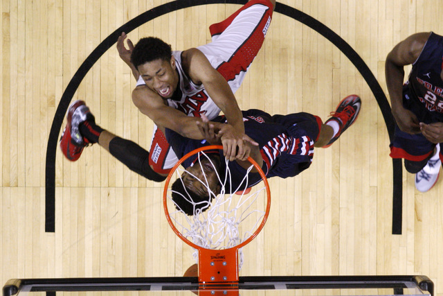 UNLV forward Christian Wood dunks on Fresno State guard Julian Lewis during their Mountain West Conference game Tuesday, Feb. 10, 2015, at the Thomas & Mack Center. UNLV won 73-61. (Sam Morris/Las ...