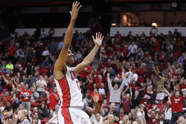 UNLV forward Christian Wood raises his arms to the student section after a seal and dunk on Fresno State during the second half of their Mountain West Conference game Tuesday, Feb. 10, 2015, at th ...