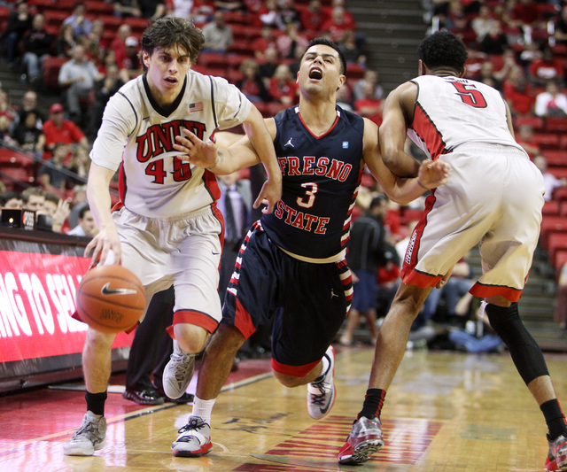 UNLV forward Christian Wood screens Fresno State guard Cezar Guerrero for teammate Cody Doolin during the second half of their Mountain West Conference game Tuesday, Feb. 10, 2015, at the Thomas & ...