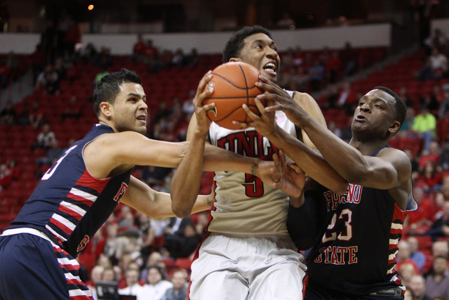 UNLV forward Christian Wood is double teamed by Fresno State guard Cezar Guerrero, left, and Fresno State guard Marvelle Harris during the second half of their Mountain West Conference game Tuesda ...