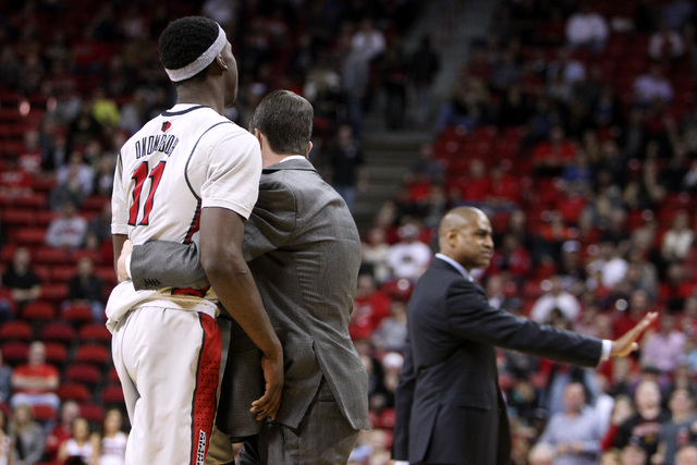 UNLV forward Goodluck Okonoboh is pulled away by Dave Rice while Fresno State head coach Rodney Terry tries to calm his players during the second half of their Mountain West Conference game Tuesda ...