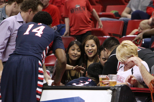 Fans react after Fresno State guard Cezar Guerrero slid over the court side table during the second half of their Mountain West Conference game against UNLV Tuesday, Feb. 10, 2015, at the Thomas & ...