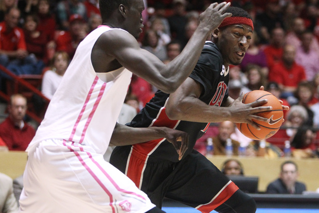 UNLV forward Goodluck Okonoboh is defended by New Mexico center Obij Aget during the second half of their Mountain West Conference game Saturday, Feb. 21, 2015, at The Pit in Albuquerque. UNLV won ...