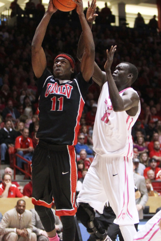 UNLV forward Goodluck Okonoboh drives past New Mexico center Obij Aget for a basket during the second half of their Mountain West Conference game Saturday, Feb. 21, 2015, at The Pit in Albuquerque ...
