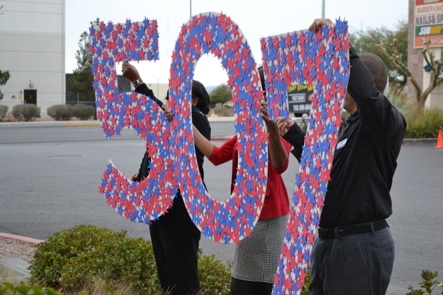 Goodwill of Southern Nevada employment specialists hold up a giant "507," symbolizing how many local veterans and immediate family members have found work, to-date, as a result of Goodwill's Veter ...