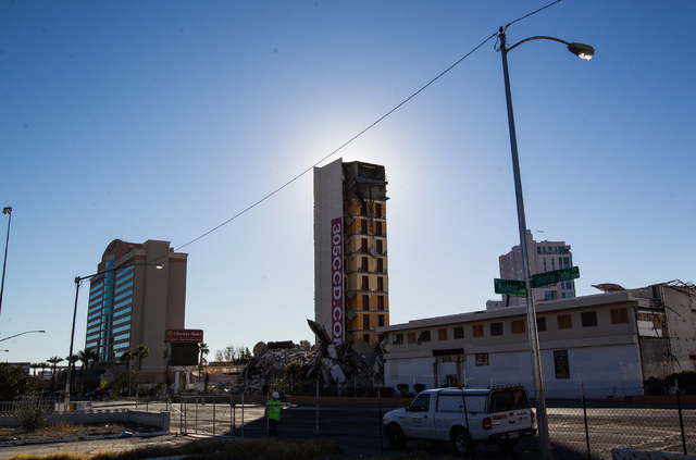 A portion of the structure of The Clarion Hotel and Casino remains, center, following an early-morning implosion at 305 Convention Center Drive in Las Vegas on Tuesday, Feb. 10, 2015. Crews are pr ...