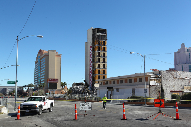 Crews prepare to topple over the remaining portion of The Clarion hotel-casino, after an early-morning implosion failed to fully bring down the building at 305 Convention Center Drive in Las Vegas ...