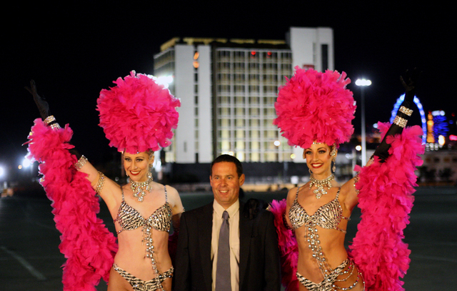 Las Vegas showgirls Jessica Land and Julie Taber from the show "Jubilee!" strike a pose with 305CCD owner, Lorenzo Doumani, in front of the Clarion Hotel and Casino before its implosion on Tuesday ...