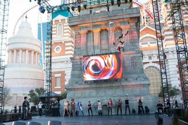 Cast members of Cirque du Soleil's Zumanity, including aerialist Brandon Pereyda, center right,  perform a portion of the show outside of the New York-New York hotel-casino in Las Vegas on Thursda ...