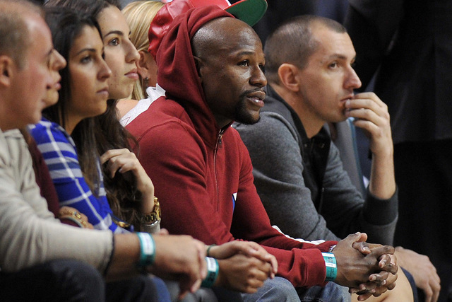 Floyd Mayweather Jr. sits courtside during the first half of an NBA game between the Milwaukee Bucks and the Miami Heat at American Airlines Arena, Jan. 27, 2015. (Steve Mitchell-USA TODAY Sports)