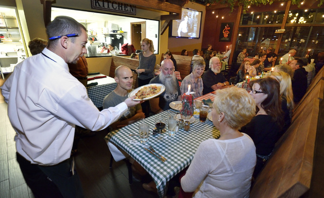 Waiter Dustin Fisher delivers an order to customers at Gabriella's Italian Grill and Pizzeria at 8878 S. Eastern Ave. in Las Vegas on Saturday, Feb. 7, 2015. (Bill Hughes/Las Vegas Review-Journal)