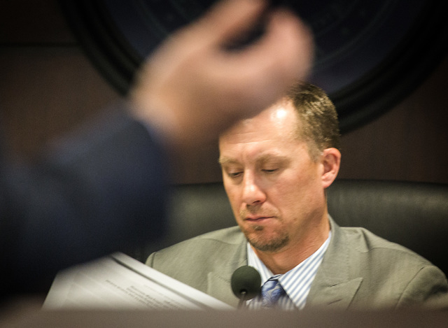 A.G. Burnett, Chairman of the Nevada State Gaming Control Board listens while Marco Sala, CEO of GTECH Holdings, speaks during a special Gaming Control Board Hearing on the licensing of the GTech- ...