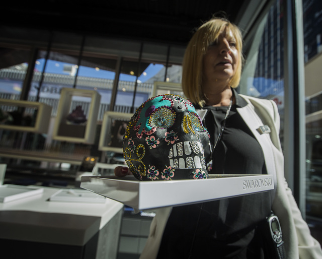 Store manager Trudell Artiglere holds a handmade Day of the Dead skull with 2200 crystals in the Swarovski store at the Grand Bazaar Shops, 3645 Las Vegas Blvd. South, on Thursday, Feb 26, 2015. T ...