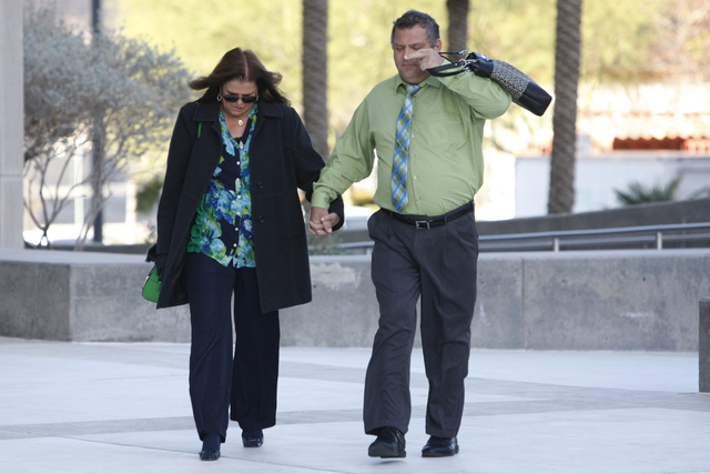 David Ball, right, co-defendant in a federal case involving fraud and corruption at Las Vegas homeowners associations, walks to Lloyd George Federal Courthouse in Las Vegas with an unidentified wo ...