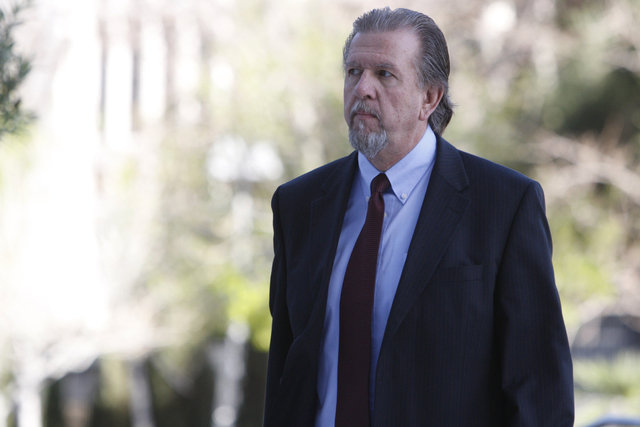 Keith Gregory, attorney and defendant in a federal case involving fraud and corruption at Las Vegas homeowners associations walks to Lloyd George Federal Courthouse in Las Vegas Wednesday, Feb. 25 ...