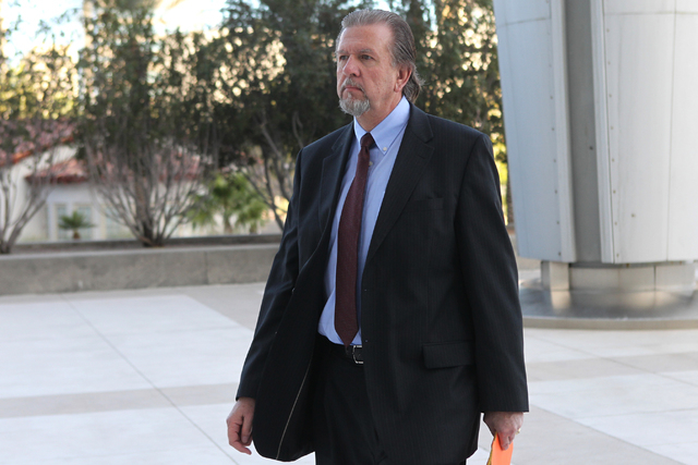 Keith Gregory, attorney and defendant in a federal case involving fraud and corruption at Las Vegas homeowners associations walks to Lloyd George Federal Courthouse in Las Vegas Wednesday, Feb. 25 ...