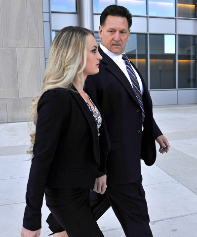 Former Family Court Judge Steven Jones, right, arrives at U.S. Federal Court with his daughter, Ashley Jones, in Las Vegas Wednesday, Feb. 25, 2015. Steven Jones was scheduled to appear for senten ...
