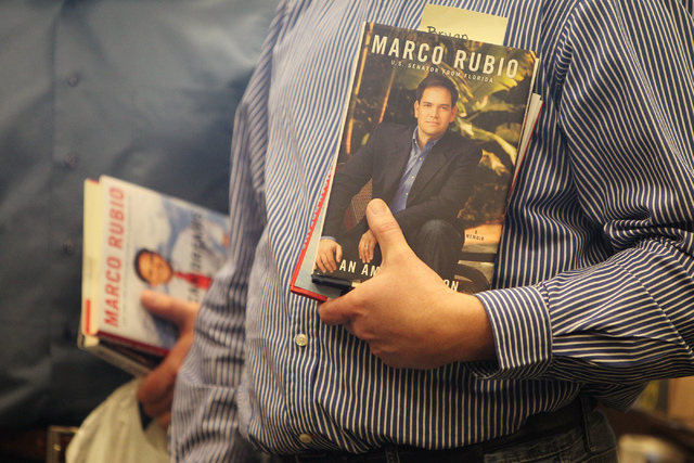 Bryan Thiriot holds a book by U.S. Sen. Marco Rubio, R-Fla., as he waits in line to get it signed at Barnes and Noble, 2191 N. Rainbow Blvd. Wednesday, Feb. 18, 2015. (Erik Verduzco/Las Vegas Revi ...