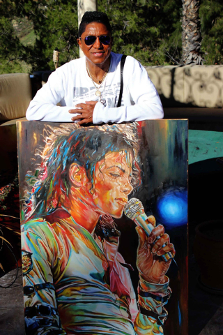 Jermaine Jackson is seen in this photo from January 2015 at his California home, holding a painting of his late brother Michael Jackson by local artist Alex Krasky. (Special to View)