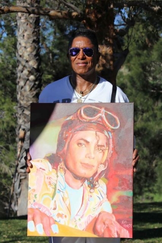 Jermaine Jackson is seen in this photo from January 2015 at his California home, holding a painting by local artist Alex Krasky. Krasky, who made Las Vegas his base, gave 10 paintings he'd done of ...
