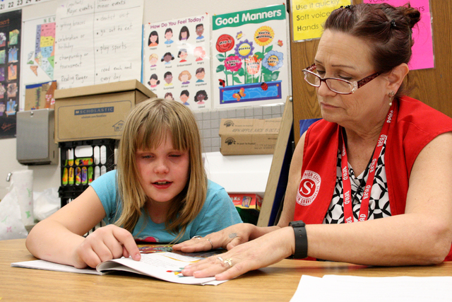 Katie Samson, 8, sits and reads with Mary Astorga as part of the Foster GrandparentProgram to help children learn to read at the Richard Rundle Elementary School in Las Vegas. Tuesday, February 17 ...