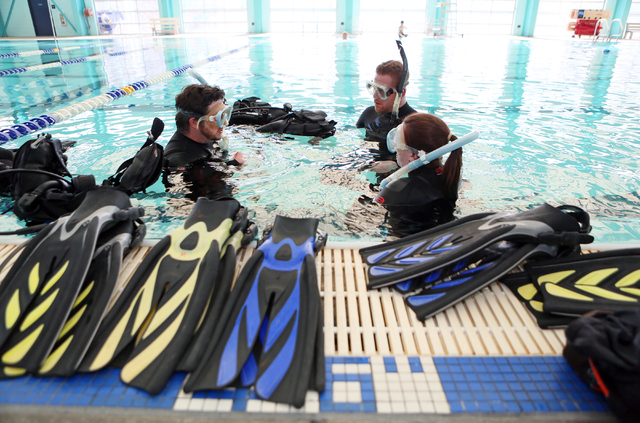 Levi Henley, from left, Scuba Views scuba diving instructor, works with students Trevor Workhoven and Jennie Day during a scuba diving lesson at Las Vegas Municipal Pool Wednesday, Feb. 11, 2015,  ...