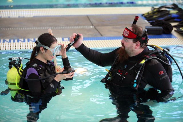 Eric Duckro, right, assistant manager of Scuba Views and scuba diving instructor, works with View reporter Sandy Lopez during a lesson at Las Vegas Municipal Pool Wednesday, Feb. 11, 2015, in Las  ...