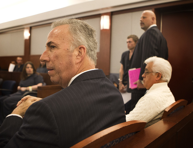 Clark County District Attorney Steve Wolfson, left, listens while Erich Nowsch, center in background,appears for his initial appearance Monday, Feb 23, 2015, in Las Vegas Justice Court at Regiona ...