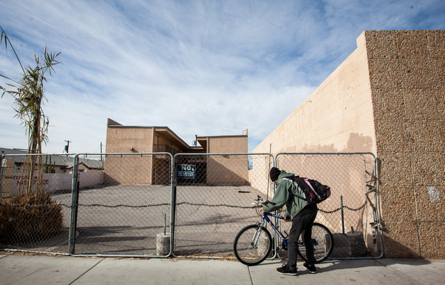 Russell Yeager sets his bike against a fence before checking out a local shop specializing in occult and artisan goods on 3rd Street near Imperial Avenue in the downtown area of Las Vegas on Frida ...