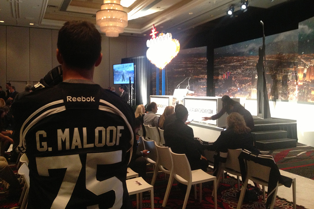 A man dressed as a NHL hockey player with a Gavin Maloof jersey plays a part in the NHL Las Vegas ticket drive press conference on Tuesday, Feb. 10,2015. With NHL Commissioner Gary Bettman looking ...