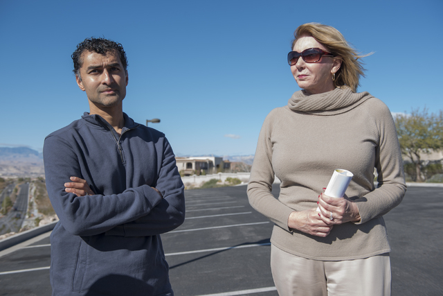Sun City Anthem resident Sam Vott, left, and shopping center tenant Diana Redman talk about their concerns regarding a proposed medical marijuana dispensary near their homes and business from the  ...