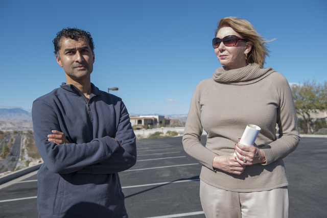 Sun City Anthem resident Sam Vott, left, and shopping center tenant Diana Redman talk about their concerns regarding a proposed medical marijuana dispensary near their homes and business from the ...