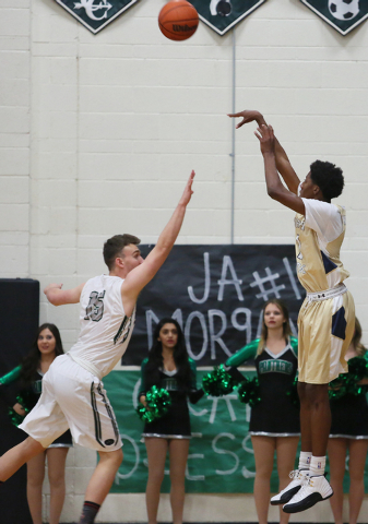 Shadow Ridge's Jerell Springer, right, shoots the ball over Palo Verde's Nick Cavaleri during a basketball game at Palo Verde High School Tuesday, Feb. 10, 2015, in Las Vegas. Palo Verde won 77-71 ...