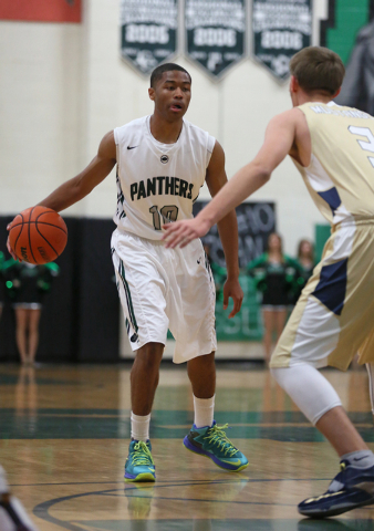 Palo Verde's Ja Morgan, left, has control of the ball and is guarded by Shadow Ridge's Brett Meci during a basketball game at Palo Verde High School Tuesday, Feb. 10, 2015, in Las Vegas. Palo Verd ...